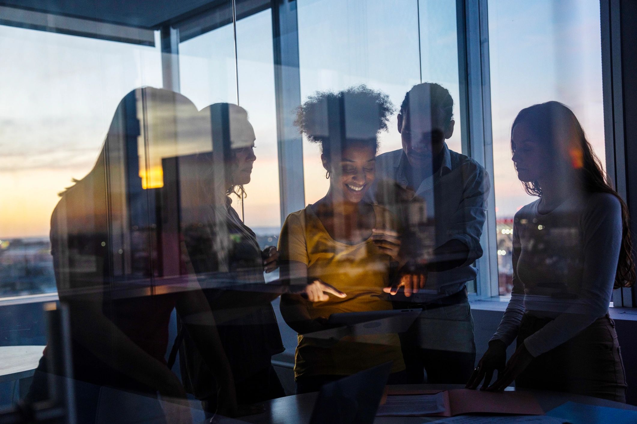 Grupo de profesionales reunidos colaborando en un entorno corporativo innovador